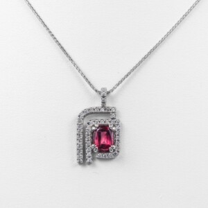 A Pendant in 14kwhite gold based on the logo of Planned Parenthood with .50cts of diamonds with a center Rare Rhodolite Garnet