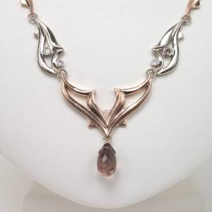 A 14k white and rose gold necklace with  a 4.50ct Rose Tourmaline  with .34cts of cognac diamonds  St. Peter's Ch