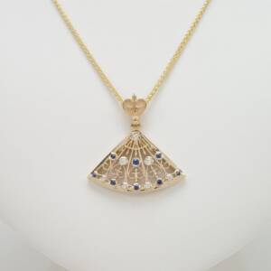 A 14k yellow gold pendant with .25cts of sapphires and .16cts of diamonds Albany City Hall