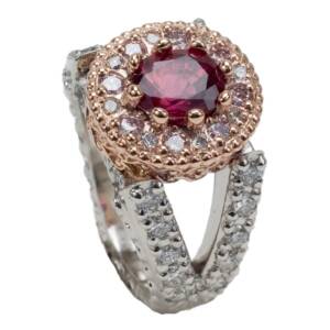 A Platinum and 14K rose gold ring with a 1.62ct Peigeon blood ruby, .71cts white diamonds $.24cts Pink diamonds