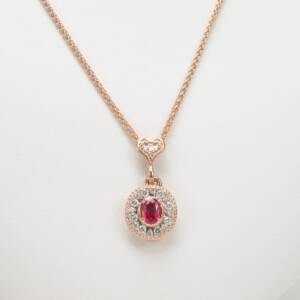 A 14k rose ghold pendant with .66cts ruby and .35cts in diamonds