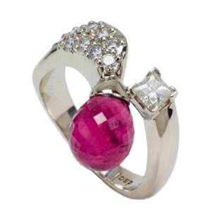 A 14k white gold ring with a 3.83ct Pink Tourmaline with a .26cts Princess cut diamond and .27cts of pave set diamonds