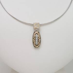 A 14k two tone pendant with .34cts of Diamonds